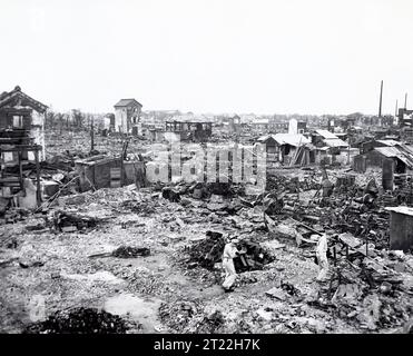 Two men walking among the rubble destroyed by bombs after U.S. Air Force air raids, Tokyo, Japan, Stanley Troutman, ACME, New York World-Telegram and the Sun Newspaper Photograph Collection, 1945 Stock Photo