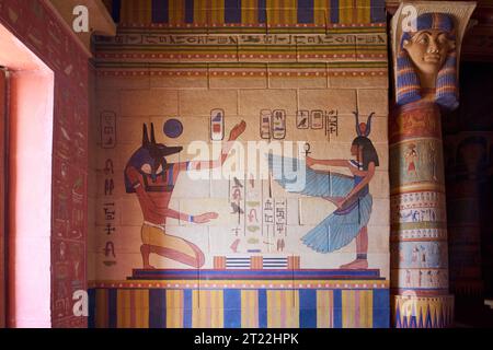 Ancient Egyptian mural depicting two figures, one with the head of a jackal representing the god Anubis and the other with the head of a cow represent Stock Photo
