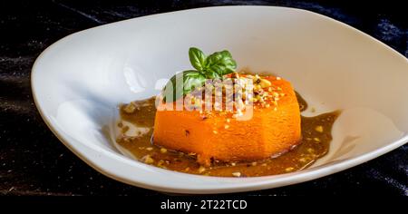 Oven baked pumpkin slices with honey, cinnamon and pistachios,healthy vegetarian food, top view Stock Photo