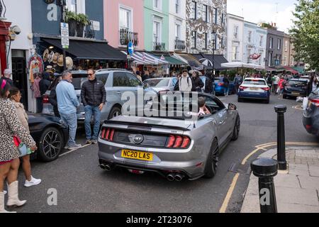 Portobello Road market, visitors, stalls, shops, cars in Notting Hill district, West London, United Kingdom Stock Photo