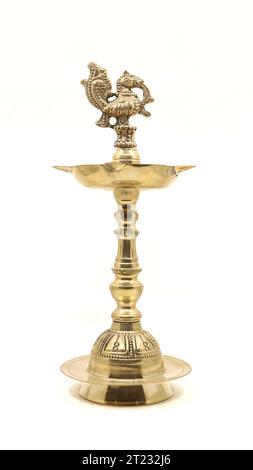 a vintage indian samai or vilakku, an oil lamp with a peacock bird emblem used to light fire and pray to god during religious events and rituals Stock Photo