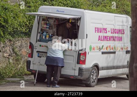 An elderly woman in Ocana, Corsica, France makes purchases from the travelling grocery that serves remote, mountain villages where there are no shops. Stock Photo