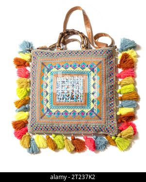 Exotic Fabric bag  with colored pompoms isolated on white background Stock Photo