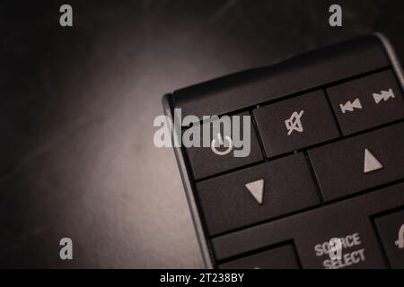 https://l450v.alamy.com/450v/2t238by/small-black-remote-with-focus-on-the-on-off-button-and-the-mute-2t238by.jpg