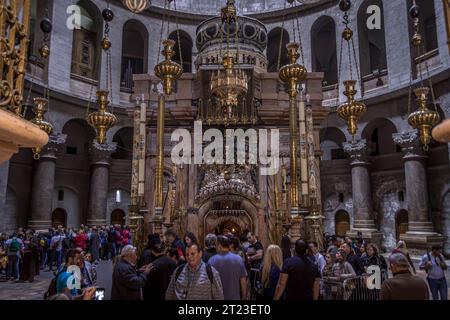 The religious Christian people around the Aedicule (alleged Jesus Christ's tomb) in the Church of the Holy Sepulchre in Old City of Jerusalem, Israel. Stock Photo