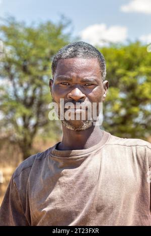 portrait of an handsome middle age african man with masculine features, standing outdoors Stock Photo