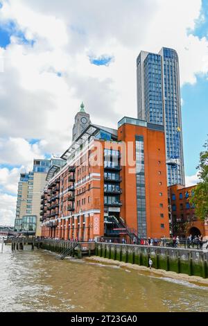 A boy walk enjoy low tide at the south bank of the River Thames, by the Oxo building London Stock Photo