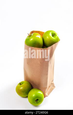 A bag of green granny smith apples in a recylclable paper bag, vertical Stock Photo