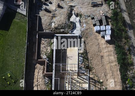 Aerial view of a construction site in progress, showcasing various construction materials and ongoing activities. Stock Photo