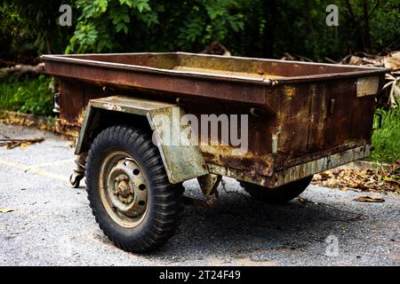 Old Abandoned Rusty Tractor Trailer. Tractor Trailer. An Old Trailer Sits On The Road. Stock Photo