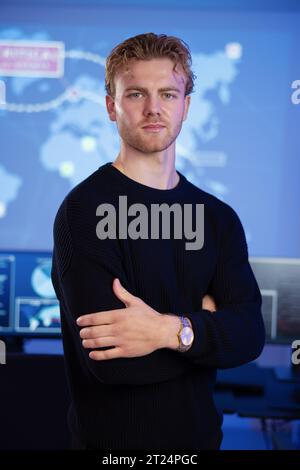 Male Cybersecurity Analyst in large Cyber Security Operation Center SOC handling Threats Stock Photo