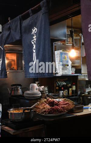 Streetfood stall serving meat on skewers, named Yakitori in Tokyo Japan. Located in Shinjuku, at Yakitori Alley (Omoide Yokocho) or Memory Lane Stock Photo