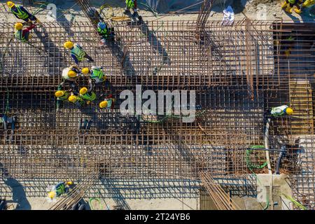 Construction workers worak at the Matarbari Power Plant is a 1,200-megawatt (2x600) coal-fired power station under construction in Maheshkhali Upazila Stock Photo