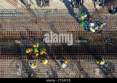 Construction workers worak at the Matarbari Power Plant is a 1,200-megawatt (2x600) coal-fired power station under construction in Maheshkhali Upazila Stock Photo