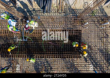 Construction workers worak at the Matarbari Power Plant is a 1,200-megawatt (2x600) coal-fired power station under construction in Maheshkhali Upazila Stock Photo