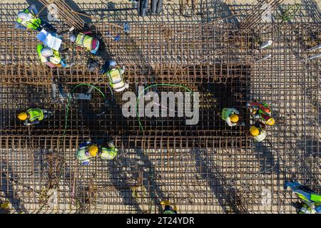 Construction workers worak at the Matarbari Power Plant is a 1,200-megawatt (2x600) coal-fired power station under construction in Maheshkhali Upazila Stock Photo