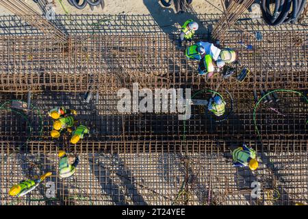 Construction workers worak at the Matarbari Power Plant is a 1,200-megawatt (2x600) coal-fired power station under construction in Maheshkhali Upazila Stock Photo