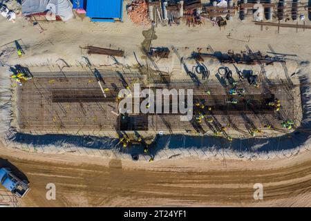 Construction workers worak at the Matarbari Power Plant is a 1,200-megawatt (2x600) coal-fired power station under construction in Maheshkhali Upazila Stock Photo