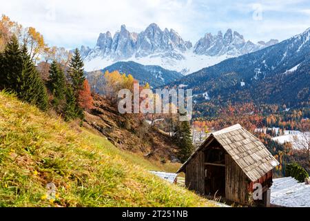 Autumn rural mountain landscape  with at аgricultural barn for hay  in the foreground, Val di Funes,  Dolomite Alps,  South Tyrol, Italy. Stock Photo