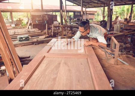 Carpenter working in a workshop, Thailand Stock Photo