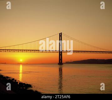 Portugal. Lisbon. 25 de Abril Suspension Bridge at sunset. Stock Photo