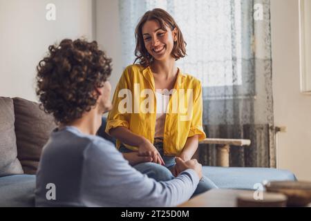 Portrait of young happy couple who is holding hands and smiling. Stock Photo