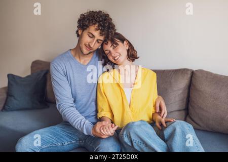 Young couple is relaxing and embracing at their home. Stock Photo