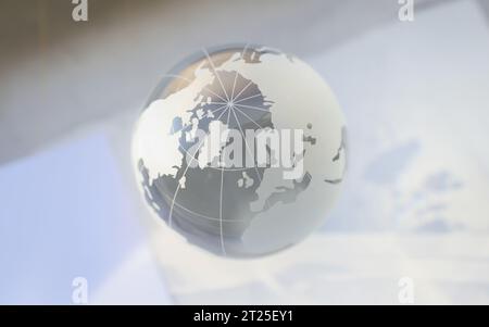 Grey glass world globe, round shaped earth miniature with continents Stock Photo