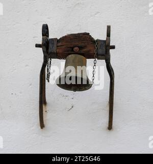small bell mounted on a wall Old Town, Evora, Alentejo, Portugal Stock Photo
