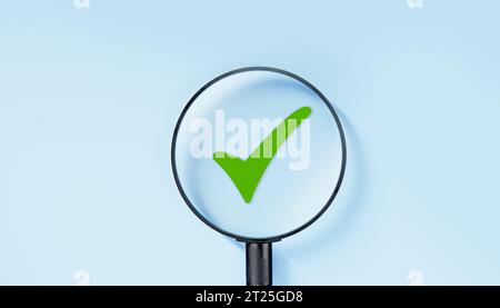 magnifying glass focuses on green tick. Check mark, Check Mark Sign, Tick Icon, right sign, green checkmark button, Done. On blue background. Banner. Stock Photo