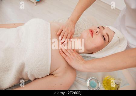 Facial massage with stones in the massage room relax spa Stock Photo