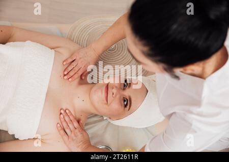 Facial massage with stones in the massage room relax spa Stock Photo