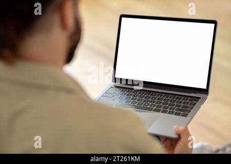 Man Using Laptop Computer With Blank White Screen Stock Photo