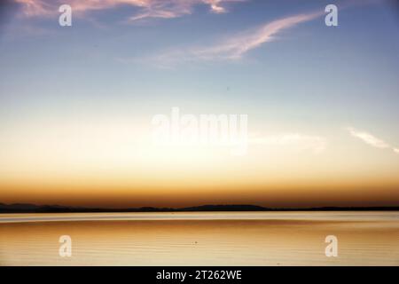 impression of lake chiemsee with golden shining light at the evening, autumn time Stock Photo