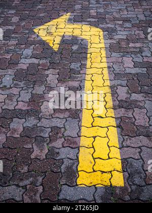 Mandatory direction arrow road marking, indicating turn left. Stock Photo