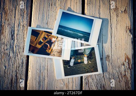 A several instant photographs lie on a wooden table. Stock Photo