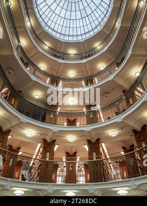 Looking up at the spectacular glass dome ceiling and tiered circular balconies inside Rotunda Hall at the National Library of Finland in Helsinki. Stock Photo