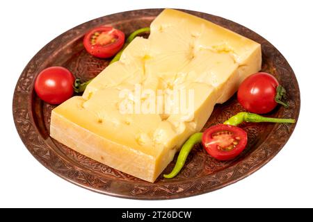 Gruyere cheese on a copper plate. Slices of gruyere cheese isolated on white background. Close up Stock Photo