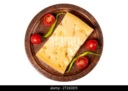 Gruyere cheese on a copper plate. Slices of gruyere cheese isolated on white background. Top view Stock Photo