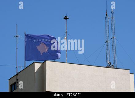 Kosovo national flags near a building of the Government of The Republic of Kosovo Stock Photo