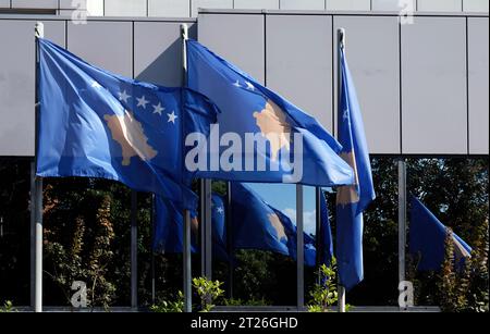 Kosovo national flags near a building of the Government of The Republic of Kosovo Stock Photo