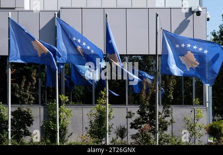 Kosovo national flags near a building of the Government of The Republic of Kosovo Stock Photo