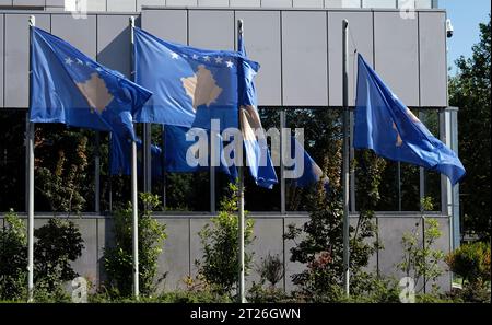 Kosovo national flags near a building of the Government of The Republic of Kosovo Stock Photo