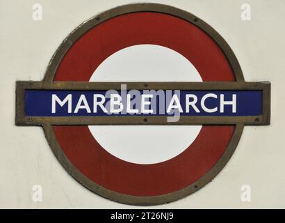 London, UK - July 4, 2008: The iconic Marble Arch station in the heart of London, UK, marked by its vibrant red and blue Metro, tube, or subway sign, Stock Photo