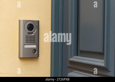 A modern surveillance camera is installed on the front door. Close-up. Stock Photo