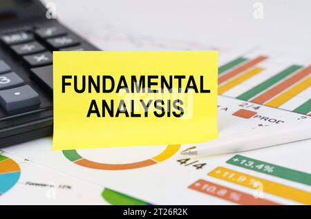 Business concept. On business reports there is a calculator and a sign with the inscription - FUNDAMENTAL ANALYSIS Stock Photo