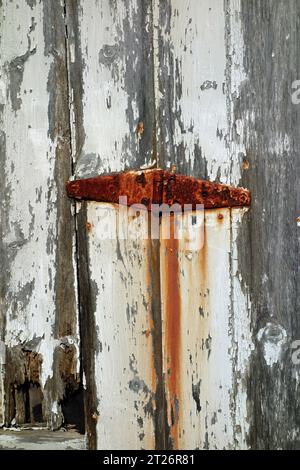 rusty hinge and cracking paint Stock Photo
