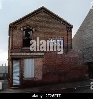 Boarded up shop with enamelled sign for 'Lyons Tea' mounted on the wall, during the Slum clearance and demolition of St Ann's, Nottingham. 1969-1972 Stock Photo