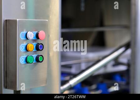 Control box of automated machine at food processing factory. Selective focus. Stock Photo