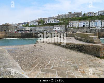 Typical english row house with bay windows above the harbour of Porthleven in Cornwall England Stock Photo